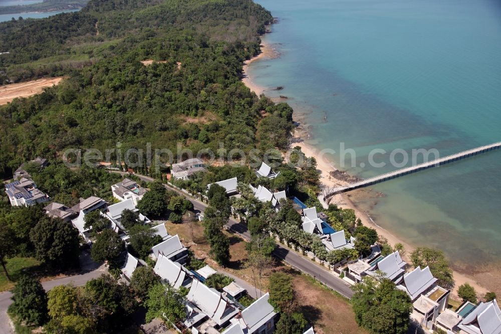 Ratsada from above - The Ko Sire Peninsula is on the eastern edge of the island of Phuket in Thailand, with villas, hotels and pier on the beach