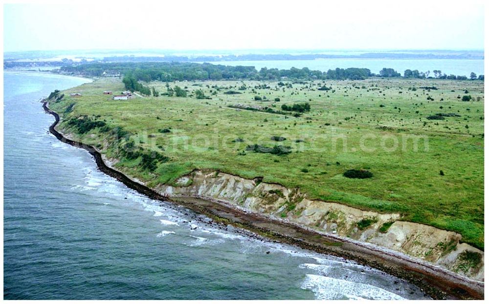 Aerial photograph Wustrow - 15.08.2004, Halbinsel Wustrow an der Ostsee in Mecklenburg-Vorpommern, Die Zukunft der Insel ist jetzt noch ungewiß. Planungen von Fundus über die Entwicklung (Bebauung) stießen immer wieder auf heftigen Widerspruch in Rerik, denn umstritten ist, wieviele Menschen, mit allen Folgebelastungen, die ca. 12 Kilometer lange Insel vertragen kann. Rund zwei Drittel der Insel sind Naturschutzgebiet und bieten vielen See- und Zugvögeln sowie an deren Tieren und seltenen Pflanzen ein Refugium. Ehem. Militärgelände.