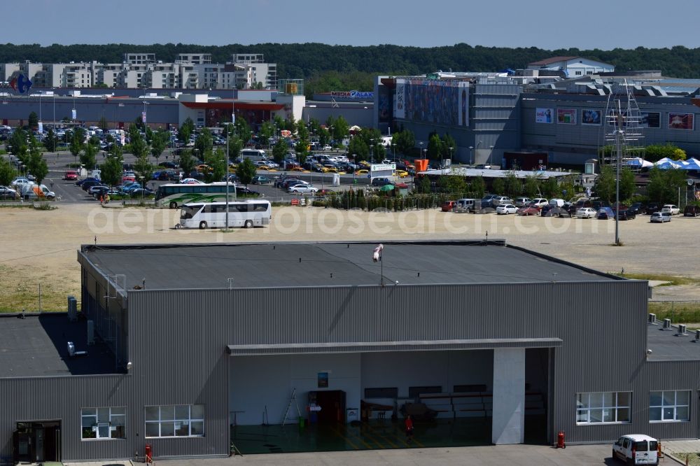 Aerial image Bukarest - Hall on the North side of Baneasa International Airport in Bucharest in Romania. Behind the hangar there is the Shopping center Baneasa with its different malls, parking lots and buildings