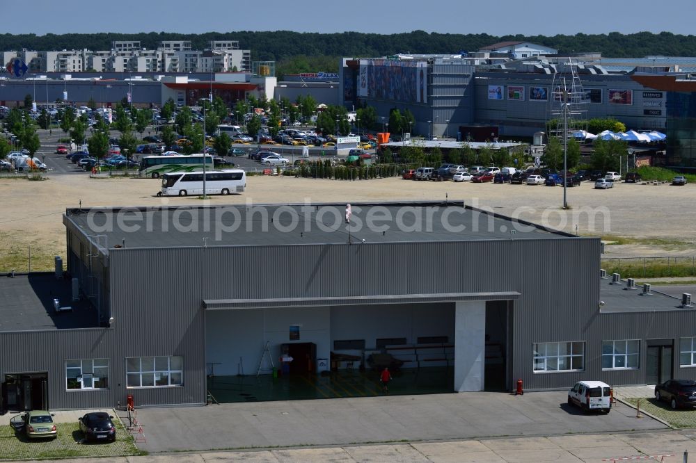 Aerial photograph Bukarest - Hall on the North side of Baneasa International Airport in Bucharest in Romania. Behind the hangar there is the Shopping center Baneasa with its different malls, parking lots and buildings