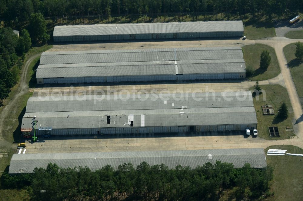 Grünheide (Mark) from the bird's eye view: Industrial and commercial area in the Hangelsberg part of the borough of Gruenheide (Mark) in the state of Brandenburg. The site includes several large halls as well as industrial and office buildings