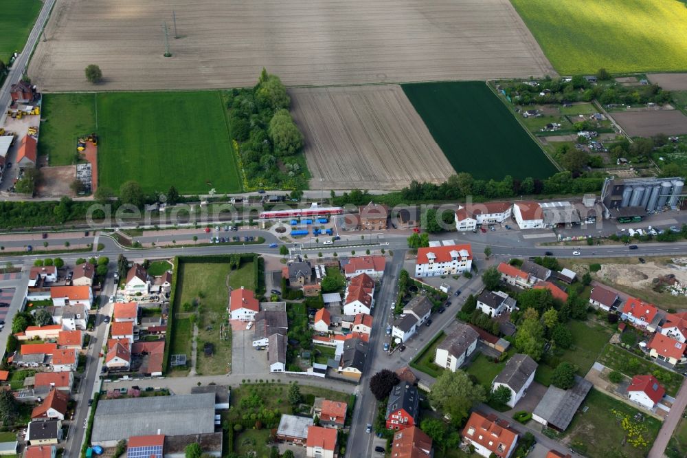 Aerial image Wörrstadt - Centrally located Train station for the rail passenger. The station is located on a small residential area with single-family homes, north extends fields and arable land. Woerrstadt in the state of Rhineland-Palatinate