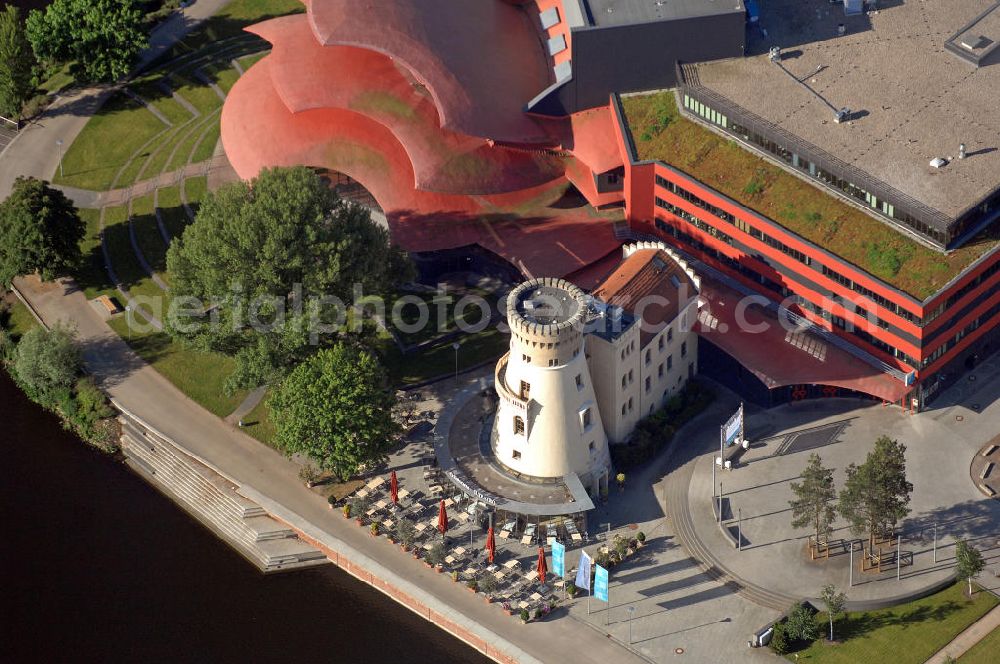 Potsdam from the bird's eye view: Blick auf das Hans Otto Theater auf dem Kultur- und Gewerbestandort in der Schiffbauergasse am Tiefen See in Potsdam. Das 2006 eröffnete Theater ist das Brandenburgischen Landestheaters, das nach dem Vorbild des Sydney Opera House vom Architekten Gottfried Böhm entworfen wurde. Vor dem Neubau steht der aus dem 19. Jahrhundert stammende Turm einer früheren Zichorienmühle, in dem ein Restaurant für gehobene Ansprüche untergebracht ist. View of the Hans Otto Theatre in the cultural and business center in the Schiffbauergasse on the lake Tiefer See in Potsdam. Opened in 2006, the Theatre is the Brandenburg State Theater, designed along the lines of the Sydney Opera House by the architect Gottfried Böhm.