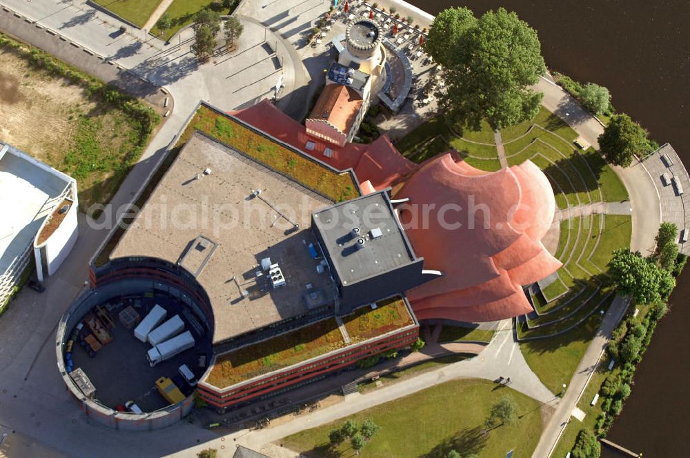 Potsdam from the bird's eye view: Blick auf das Hans Otto Theater auf dem Kultur- und Gewerbestandort in der Schiffbauergasse am Tiefen See in Potsdam. Das 2006 eröffnete Theater ist das Brandenburgischen Landestheaters, das nach dem Vorbild des Sydney Opera House vom Architekten Gottfried Böhm entworfen wurde. Vor dem Neubau steht der aus dem 19. Jahrhundert stammende Turm einer früheren Zichorienmühle, in dem ein Restaurant für gehobene Ansprüche untergebracht ist. View of the Hans Otto Theatre in the cultural and business center in the Schiffbauergasse on the lake Tiefer See in Potsdam. Opened in 2006, the Theatre is the Brandenburg State Theater, designed along the lines of the Sydney Opera House by the architect Gottfried Böhm.