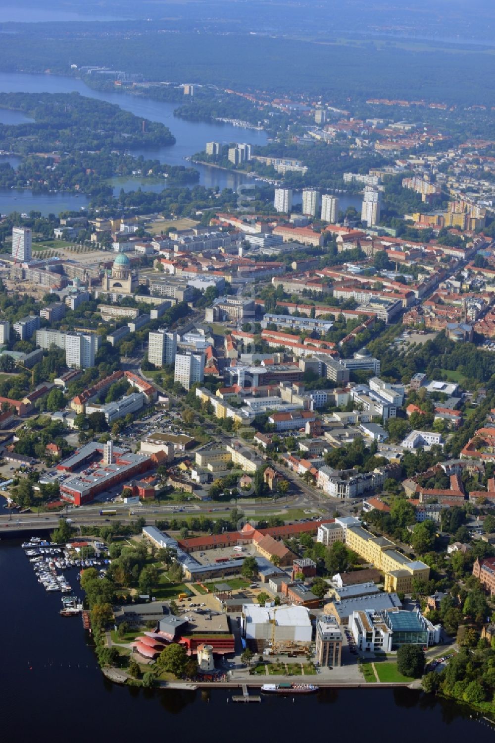 Aerial photograph Potsdam - Blick auf das Hans Otto Theater auf dem Kultur- und Gewerbestandort in der Schiffbauergasse am Ufer des Tiefen Sees in Potsdam. Das 2006 eröffnete Theater ist das Brandenburgischen Landestheaters, das vom Architekten Gottfried Böhm entworfen wurde. Vor dem Neubau steht der aus dem 19. Jahrhundert stammende Turm einer früheren Zichorienmühle, in dem ein Restaurant für gehobene Ansprüche untergebracht ist.