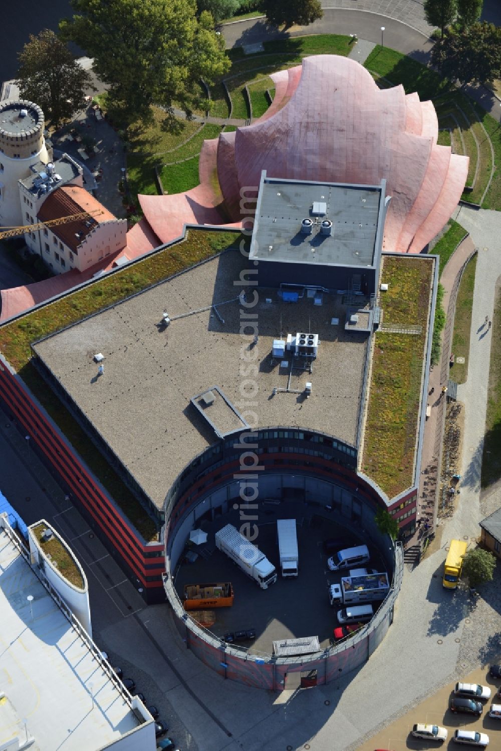 Potsdam from the bird's eye view: Blick auf das Hans Otto Theater auf dem Kultur- und Gewerbestandort in der Schiffbauergasse am Ufer des Tiefen Sees in Potsdam. Das 2006 eröffnete Theater ist das Brandenburgischen Landestheaters, das vom Architekten Gottfried Böhm entworfen wurde. Vor dem Neubau steht der aus dem 19. Jahrhundert stammende Turm einer früheren Zichorienmühle, in dem ein Restaurant für gehobene Ansprüche untergebracht ist.