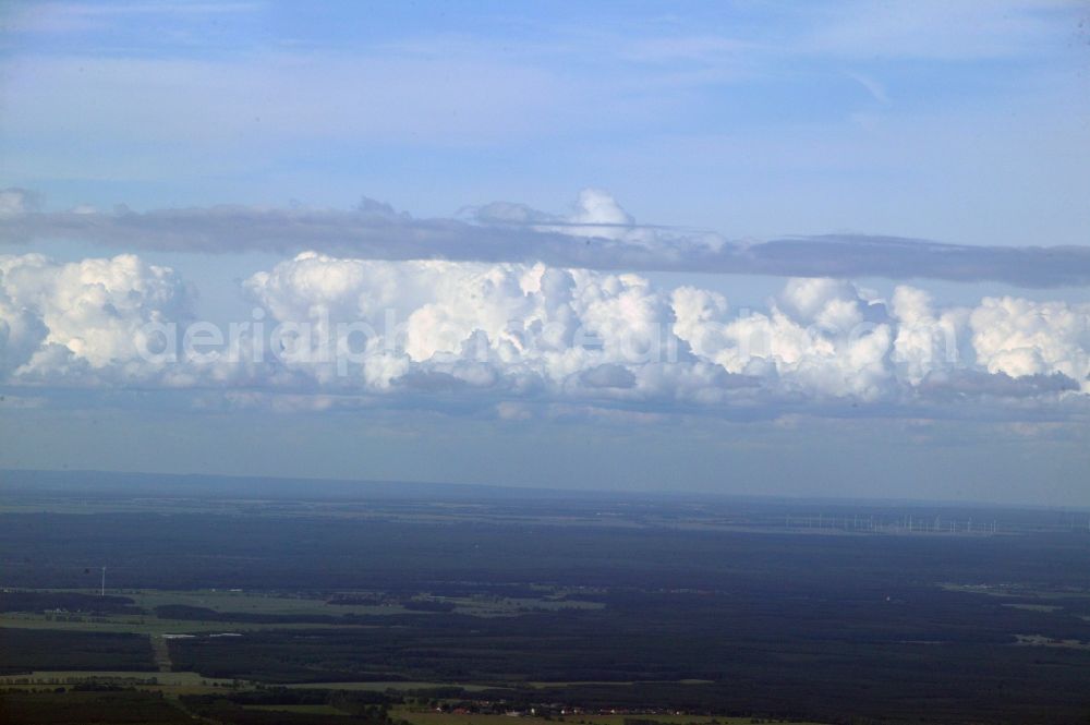 Aerial photograph Remplin - An elongated cumulus spans the region at the Mecklenburg Switzerland Remplin in the state of Mecklenburg-Vorpommern. In the background wind turbines can be seen