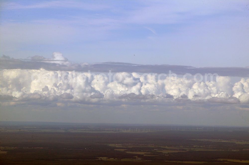 Remplin from the bird's eye view: An elongated cumulus spans the region at the Mecklenburg Switzerland Remplin in the state of Mecklenburg-Vorpommern. In the background wind turbines can be seen