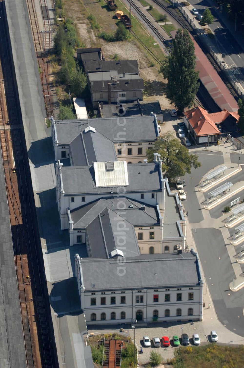 Aerial photograph Zittau - Blick auf den Zittauer Hauptbahnhof in Sachsen. Zittau liegt in der Oberlausitz und ist eine Große Kreisstadt im Landkreis Görlitz. Der große Zittauer Bahnhof zeigt sich in einem schönen klassizistischen Stil. Der Hauptbahnhof Zittau wurde im Jahr 1859 eröffnet und im Jahr 2001 umfangreich saniert. Außerdem ist der Bahnhof seit 1890 Ausgangspunkt der Zittau-Oybin-Jonsdorfer-Eisenbahn (ZOJE), auch bekannt als 'Zittauer Schmalspurbahn'. Kontakt: Sächsisch-Oberlausitzer Eisenbahngesellschaft mbH, Tel. +49 035 83 54 05 40,