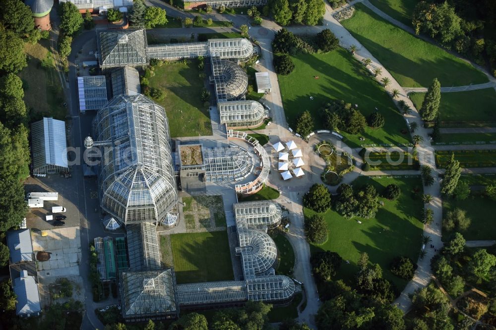 Berlin from above - Main building and greenhouse complex of the Botanical Gardens Berlin-Dahlem in Berlin. The historical glass buildings and greenhouses are dedicated to different areas. The Large Tropical House and the Victoria-House are located in the center