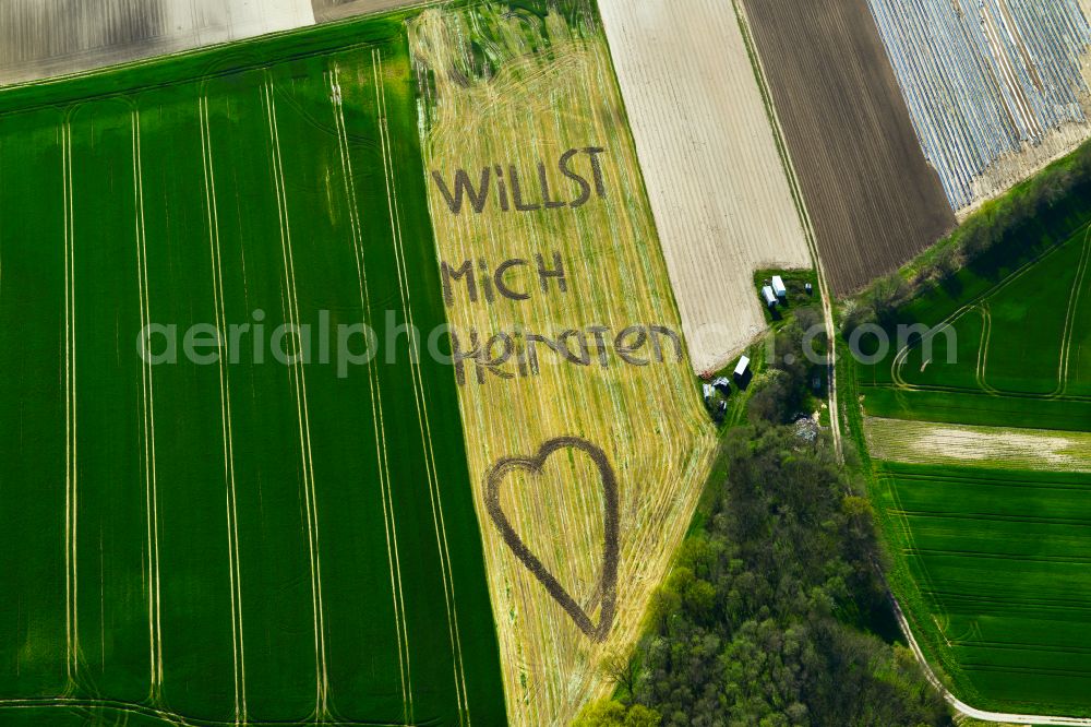 Aerial image Wiesentheid - Marriage proposal as lettering Willst marry me with a heart in grain field structures in Wiesentheid in the state Bavaria, Germany