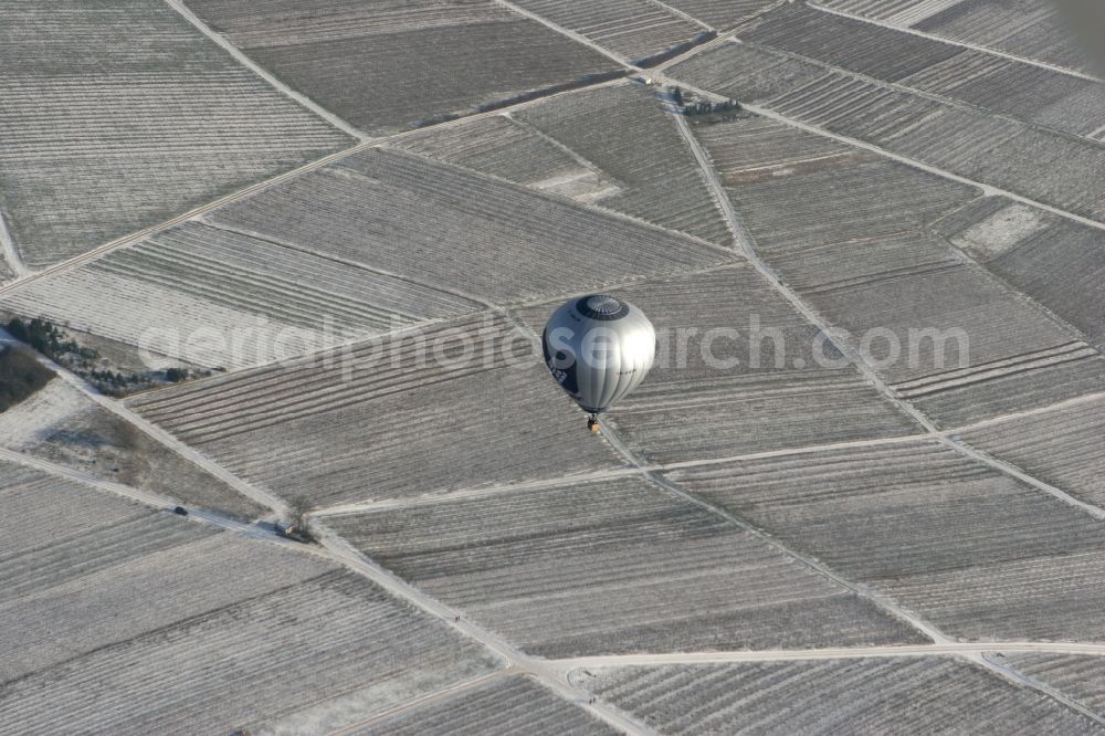 Aerial image Winzenheim - Hot air balloon over winter covered with snow field landscape on the outskirts of Winzenheim, a district of Bad Kreuznach in Rhineland-Palatinate