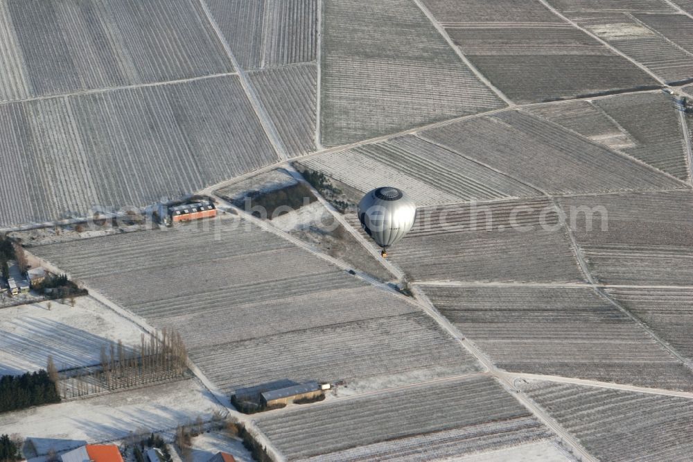 Aerial photograph Winzenheim - Hot air balloon over winter covered with snow field landscape on the outskirts of Winzenheim, a district of Bad Kreuznach in Rhineland-Palatinate