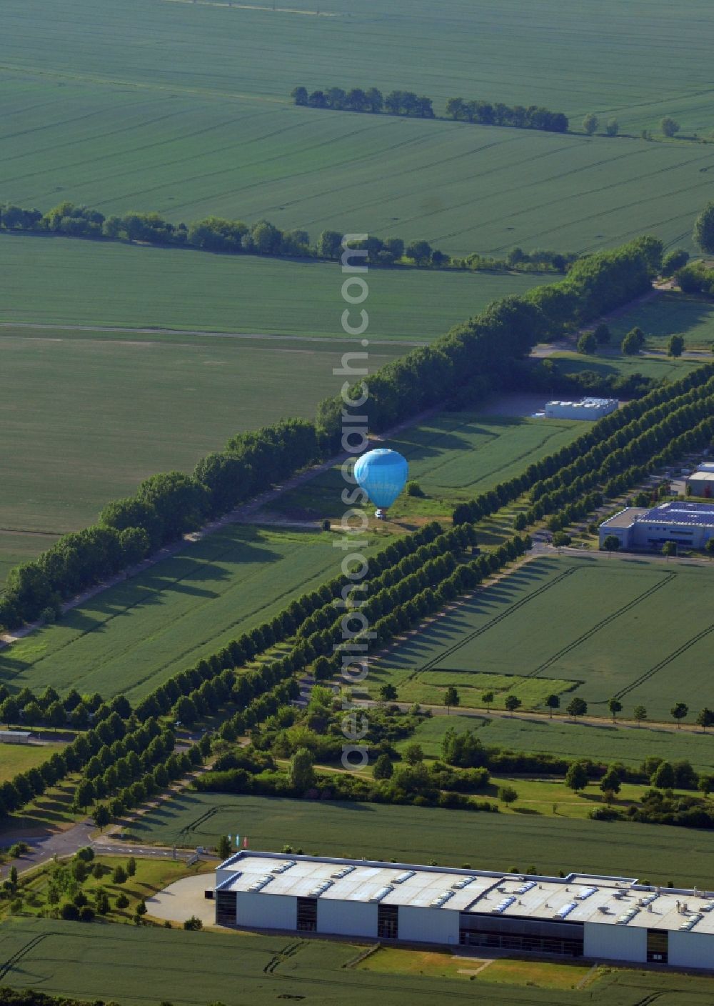 Aerial image Barleben - Hot air balloon on a field in Barleben in the state of Saxony-Anhalt. The borough is located in the North of Magdeburg and is an important economy location. The blue balloon is located in a commercial and industrial area along Otto-Von-Guericke-Allee