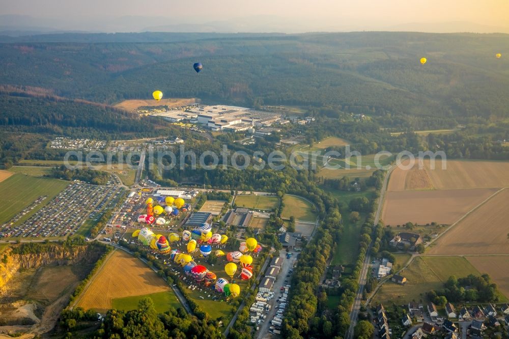 Warstein from the bird's eye view: Hot air balloon Warsteiner Montgolfiade flying over the airspace in Warstein in the state North Rhine-Westphalia, Germany