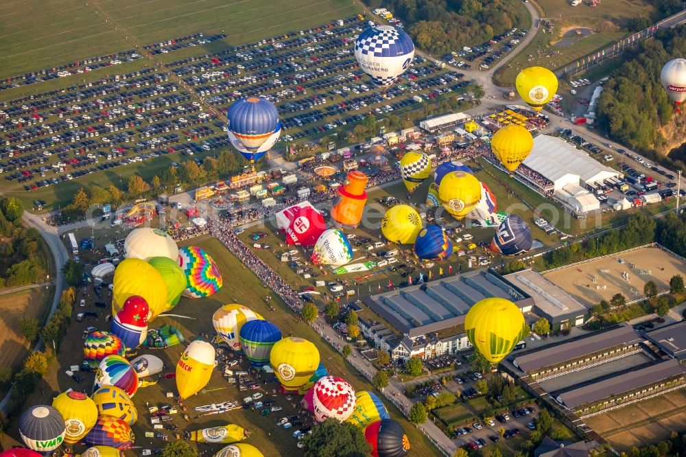 Warstein from the bird's eye view: Hot air balloon Warsteiner Montgolfiade flying over the airspace in Warstein in the state North Rhine-Westphalia, Germany