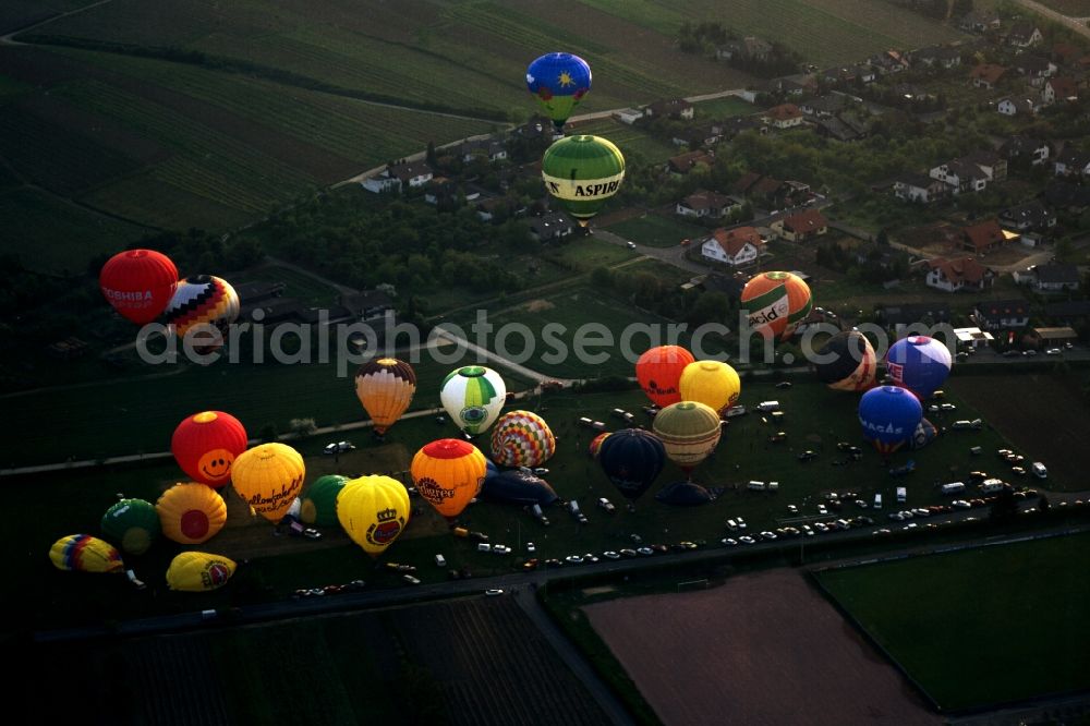 Aerial image Volkach - Hot-air balloons in Volkach in the Lower Franconia region of the state of Bavaria. The city is located on the river Main in the main-franconian winery region. The balloons are just taking off for the night glowing event