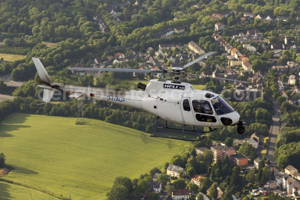 Aerial image Witten - Helicopter HELI AG with the registration D-HAUP when shooting in flight over Witten in the state of North Rhine-Westphalia