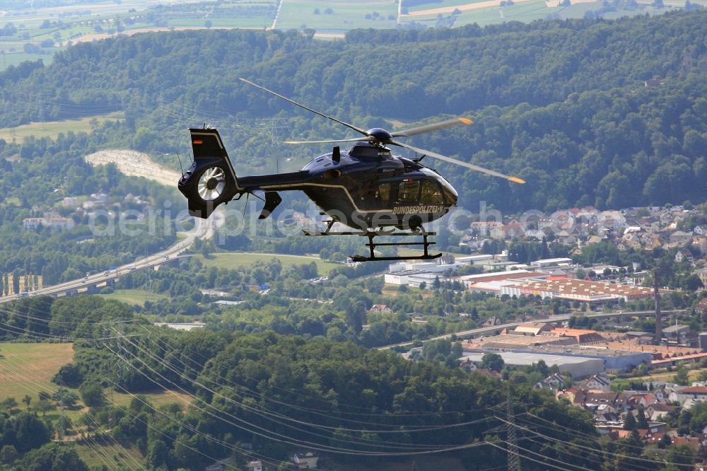 Aerial photograph Lörrach - Helicopter in flight EC 135 of federal police mission D-HVBD over the air space in Loerrach in the state Baden-Wuerttemberg