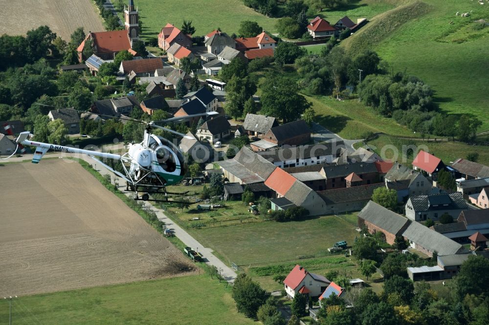 Aerial image Riesigk - Helicopter in flight Hughes 300 - Schweizer 300C call sign D-HANK over the air space in Riesigk in the state Saxony-Anhalt
