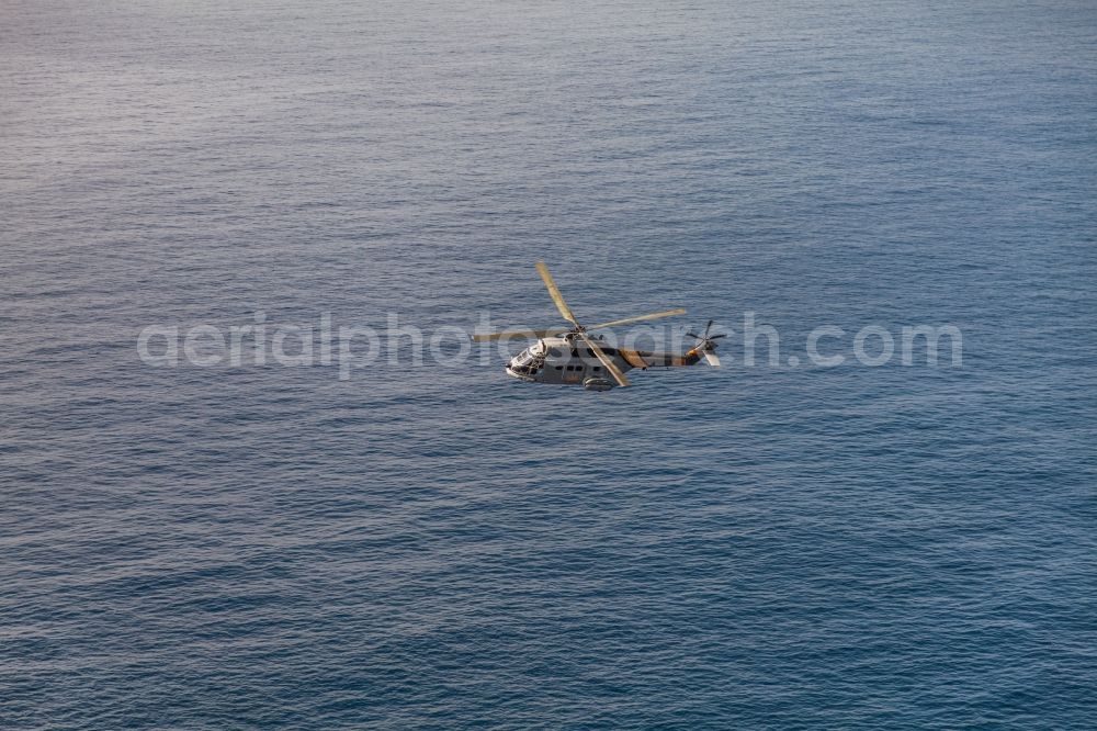 Palma from the bird's eye view: Helicopter in flight Rettungshubschrauber SAR Aerospatiale SA 330 Puma over the air space in Palma in Balearic Islands, Spain