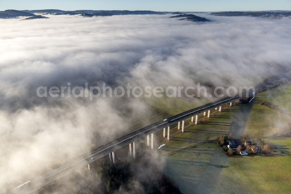 Meschede from the bird's eye view: Autumn - fog weather landscape over the building of the motorway A46 - Viaduct Wennemen in Meschede in the state of North Rhine-Westphalia