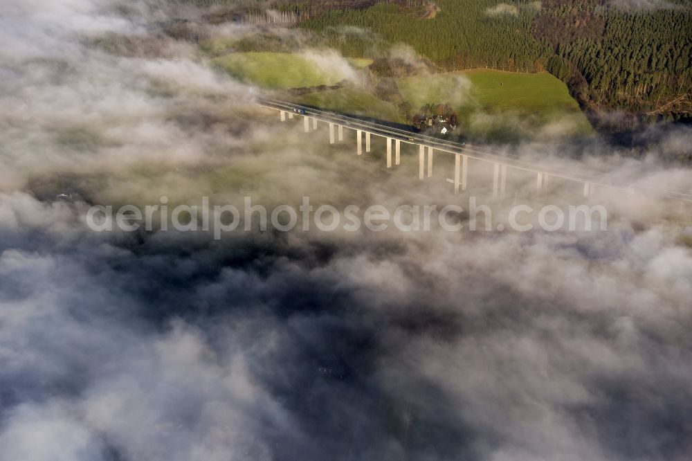 Meschede from the bird's eye view: Autumn - fog weather landscape over the building of the motorway A46 - Viaduct Wennemen in Meschede in the state of North Rhine-Westphalia