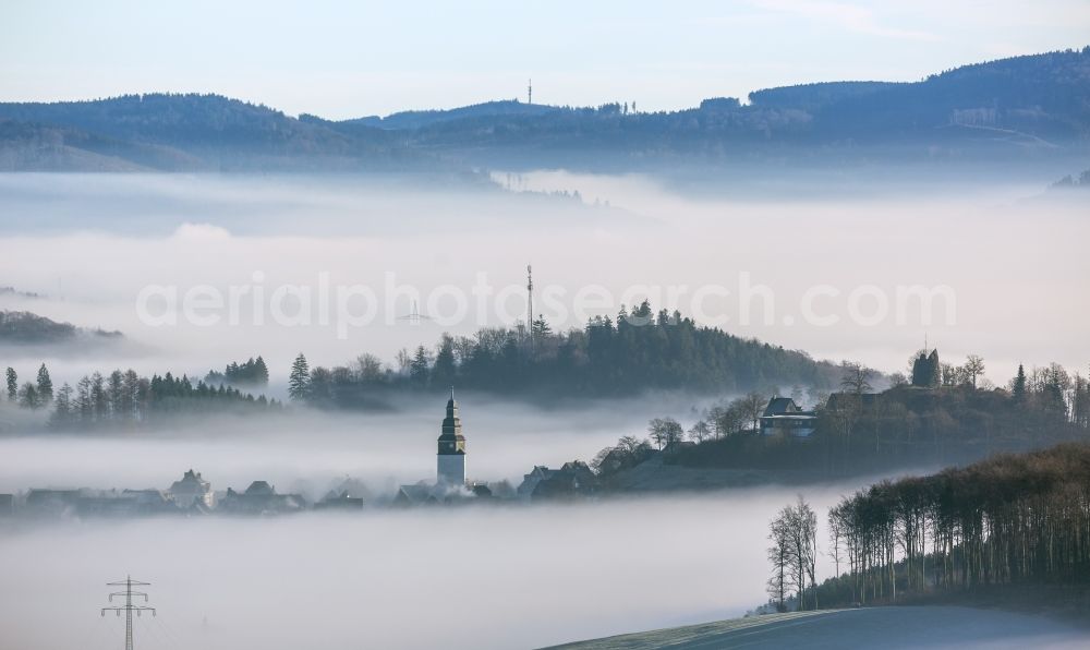 Meschede OT Bergstadt Eversberg from the bird's eye view: Autumn - Weather landscape over the space enclosed by clouds and haze district Eversberg in Meschede in the state of North Rhine-Westphalia