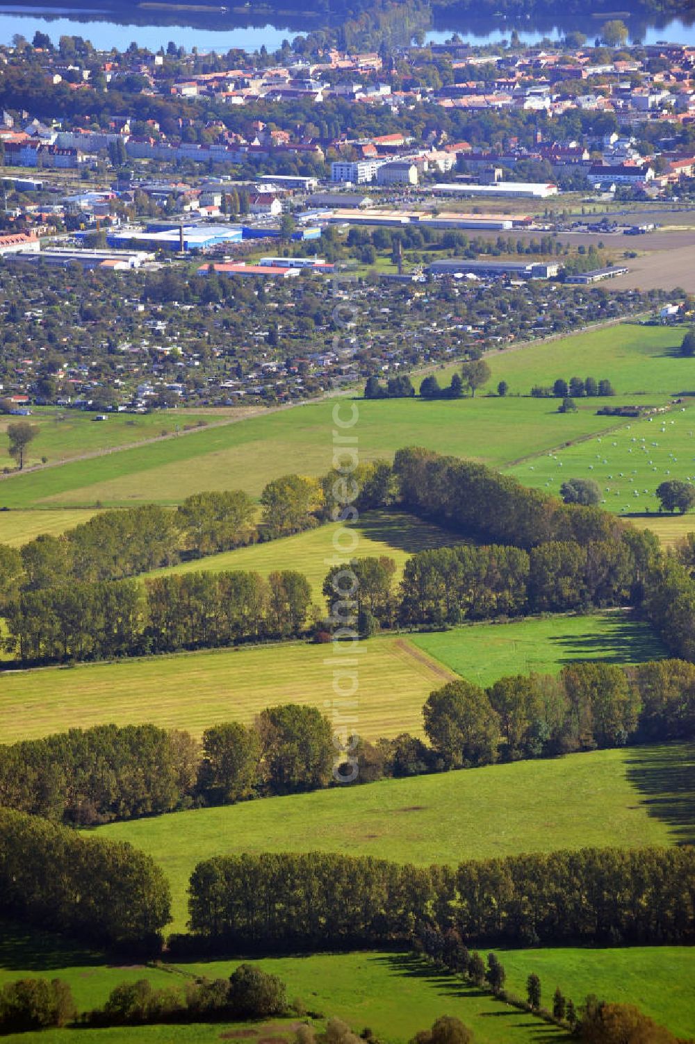 Aerial image Neuruppin - Herbstlandschaft mit von Bäumen eingezäunte landwirtschaftliche Nutzflächen in der Ostpriegnitz, bei Neuruppin in Brandenburg. Autumn landscape near Neuruppin in Ostpriegnitz, Brandenburg. You can see fields surrounded by trees.