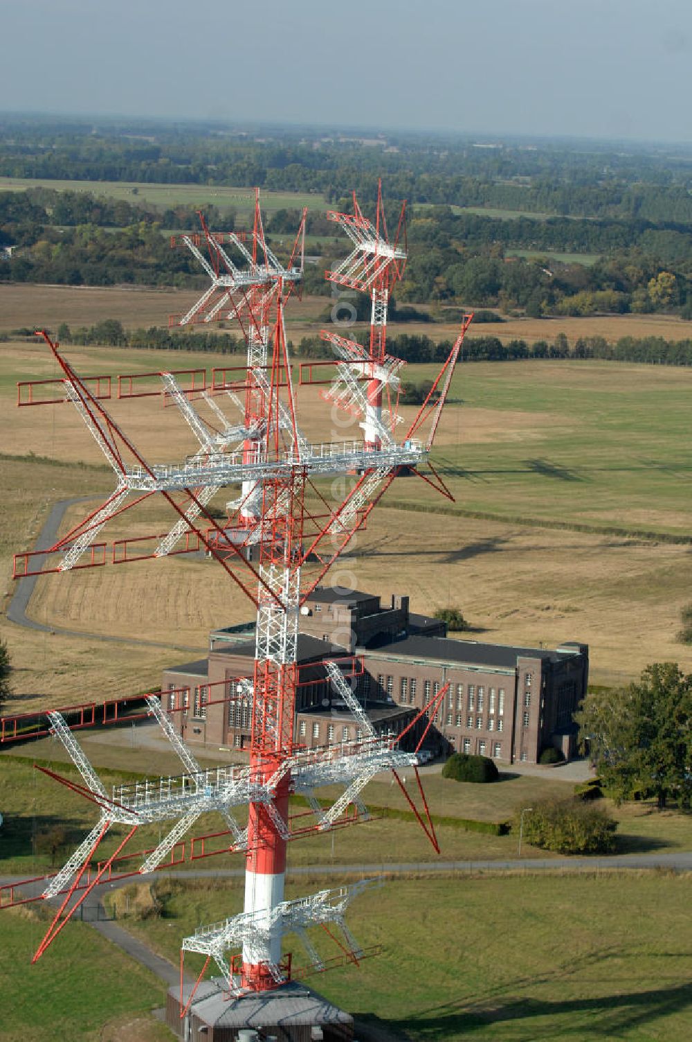 Aerial photograph NAUEN - Herbstlicher Blick auf das Areal der Kurzwellen- Rundfunksendestelle Nauen. Im Mittelpunkt Areales befindet sich das 1920 eingeweihte Muthesius-Gebäude, in dem heute die Leitstelle der vier modernen Kurzwellensender untergebracht ist. Von Nauen aus wird das Programm von DW-RADIO rund um den Globus gesendet.