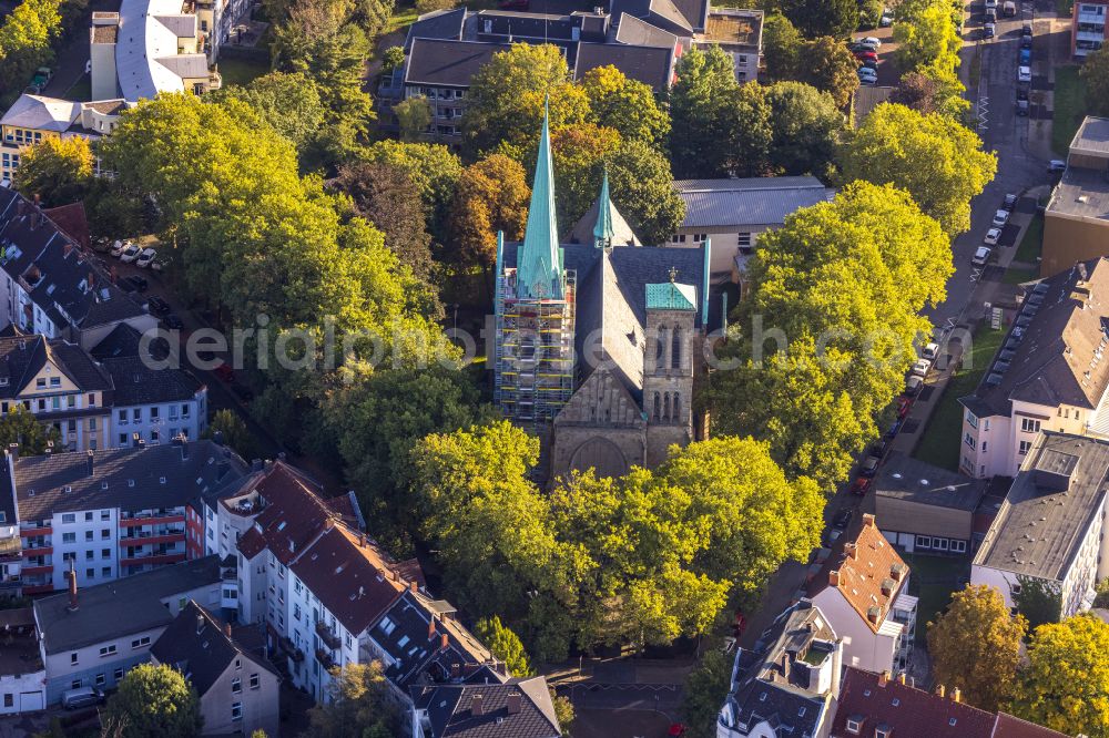 Aerial photograph Herne - Autumnal discolored vegetation view construction site for renovation and reconstruction work on the church building Herz Jesu Kirche on street Duengelstrasse in Herne at Ruhrgebiet in the state North Rhine-Westphalia, Germany