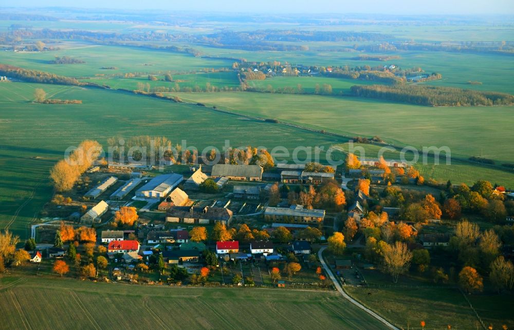Warbende from above - Autumnal discolored vegetation view on village on the edge of agricultural fields and farmland in Warbende in the state Mecklenburg - Western Pomerania, Germany