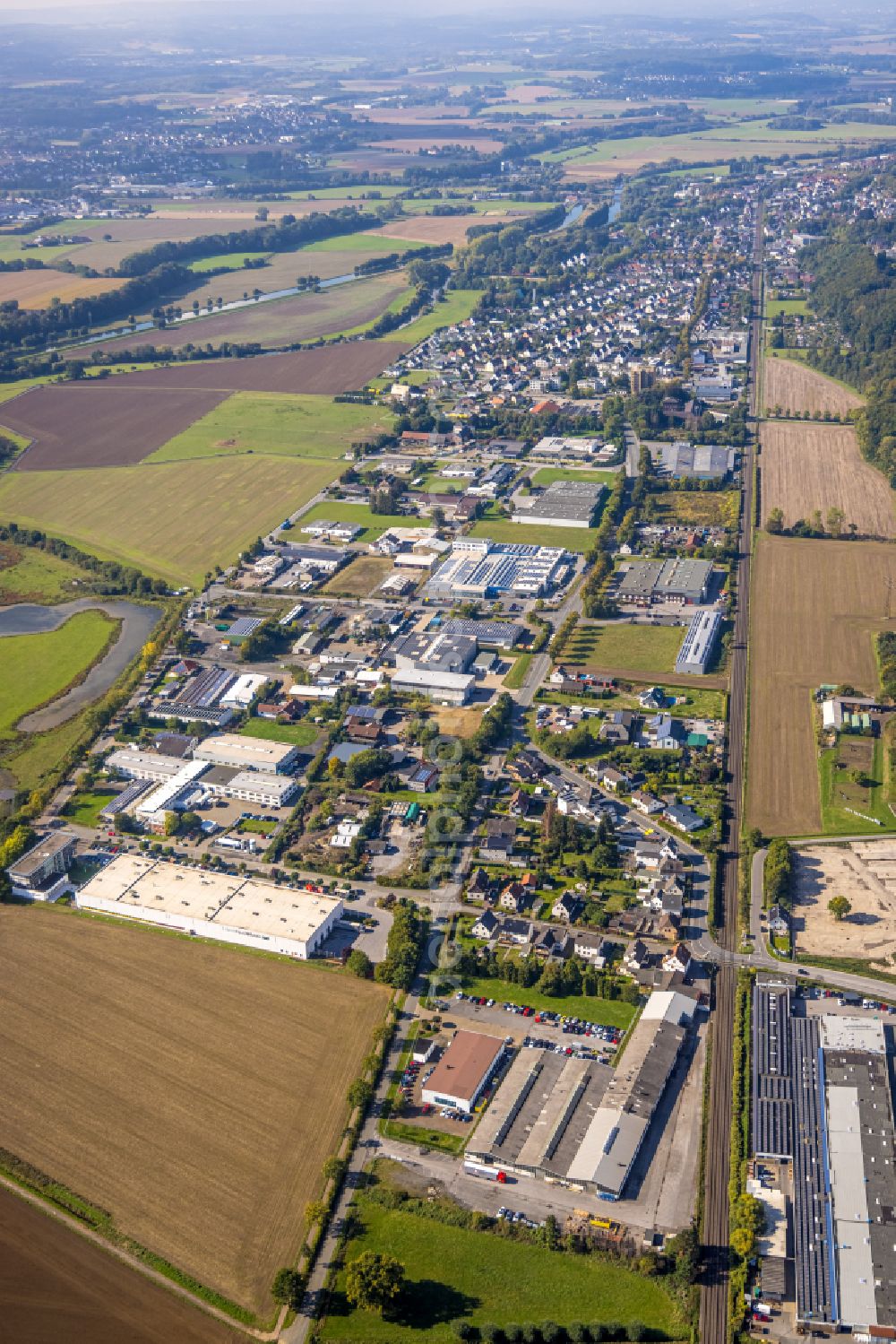 Fröndenberg/Ruhr from the bird's eye view: Autumnal discolored vegetation view industrial estate and company settlement on Werner-von-Siemens-Strasse in Froendenberg/Ruhr at Sauerland in the state North Rhine-Westphalia, Germany