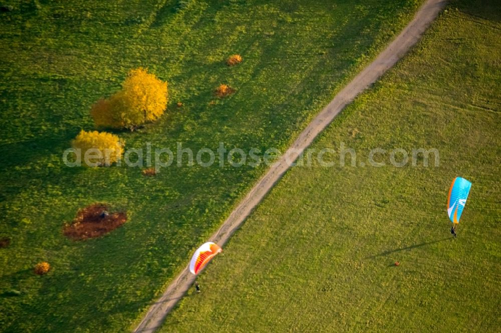 Deusen from the bird's eye view: Autumnal discolored vegetation view structures of a field landscape with paragliders in Deusen in the state North Rhine-Westphalia, Germany