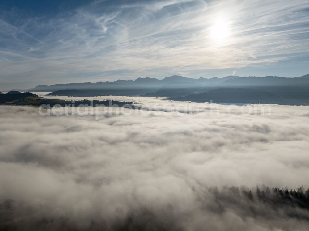 Aerial photograph Irsengund - Autumnal colored vegetation view. Weather-related fog banks and cloud layer over forest and meadow landscape in the Allgaeu in the district of Oberreute in Irsengund in the federal state of Bavaria, Germany