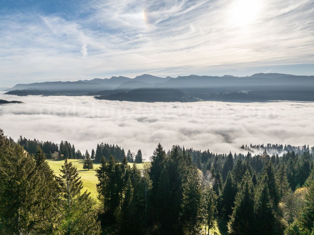 Aerial image Irsengund - Autumnal colored vegetation view. Weather-related fog banks and cloud layer over forest and meadow landscape in the Allgaeu in the district of Oberreute in Irsengund in the federal state of Bavaria, Germany