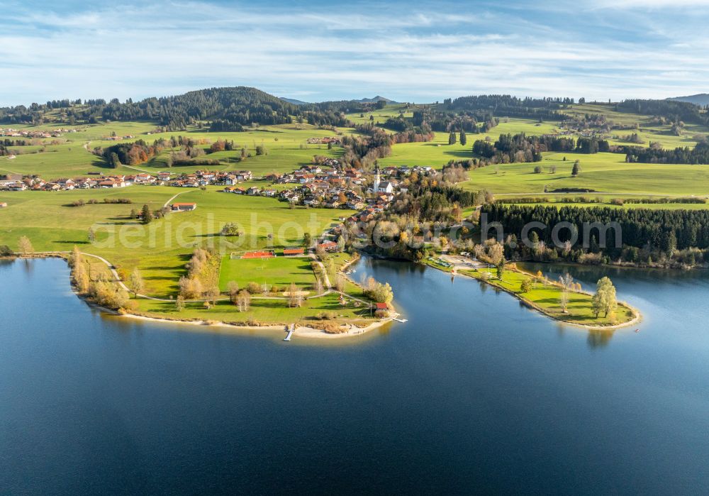 Oy-Mittelberg from above - Autumnal discolored vegetation view panoramic perspective landscape shot with the Rottach reservoir between pastures and colorful autumn forests in the upper Allgaeu in Oy-Mittelberg/ Petersthal in the state of Bavaria, Germany