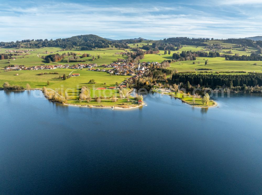 Oy-Mittelberg from the bird's eye view: Autumnal discolored vegetation view panoramic perspective landscape shot with the Rottach reservoir between pastures and colorful autumn forests in the upper Allgaeu in Oy-Mittelberg/ Petersthal in the state of Bavaria, Germany