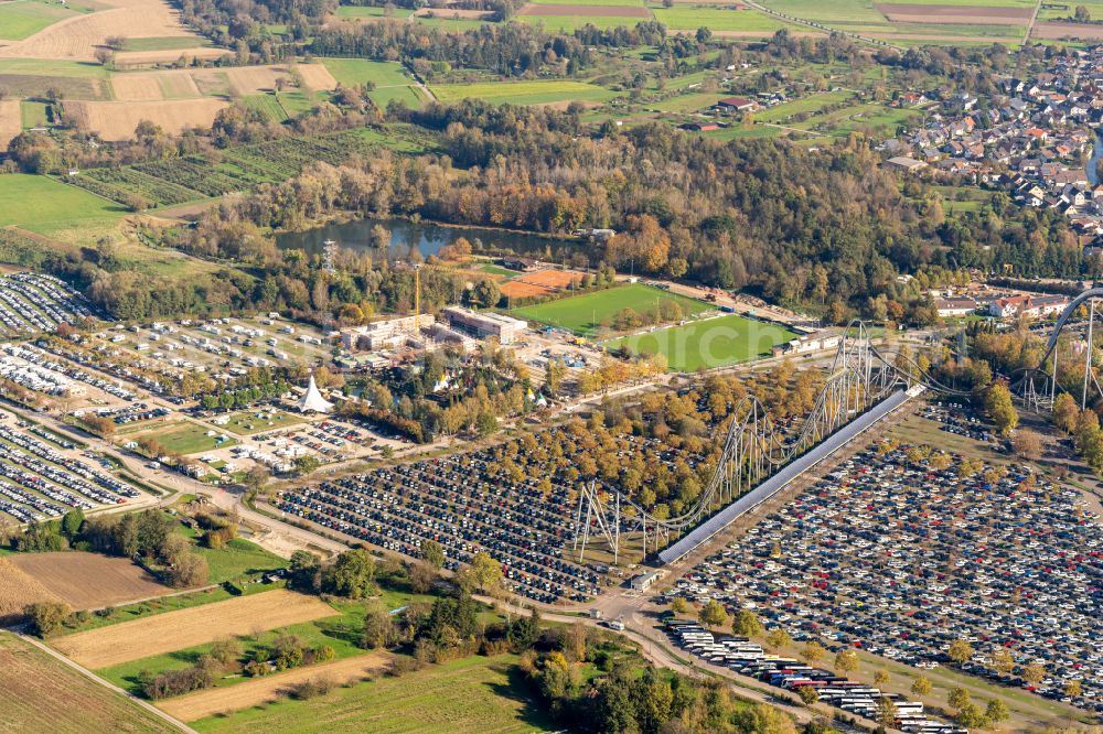 Aerial photograph Rust - Autumnal discolored vegetation view parking and storage space for automobiles on Freizeitpark in Rust in the state Baden-Wurttemberg, Germany