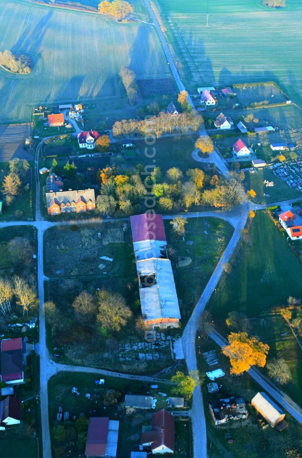 Feldberger Seenlandschaft from above - Autumnal discolored vegetation view Ruin of abandoned agricultural function building in Feldberger Seenlandschaft in the state Mecklenburg - Western Pomerania, Germany