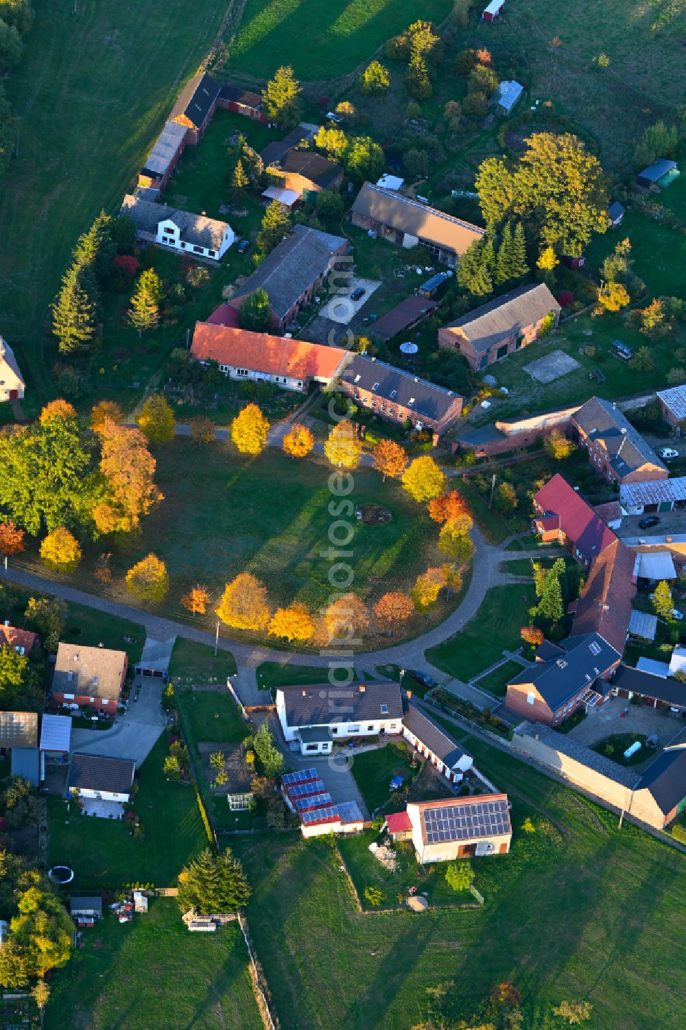 Tangendorf from above - Autumnal discolored vegetation view Village view with radiating round - shaped farmsteads and residential buildings in the center of the village on street Hauptstrasse in Tangendorf in the state Brandenburg, Germany