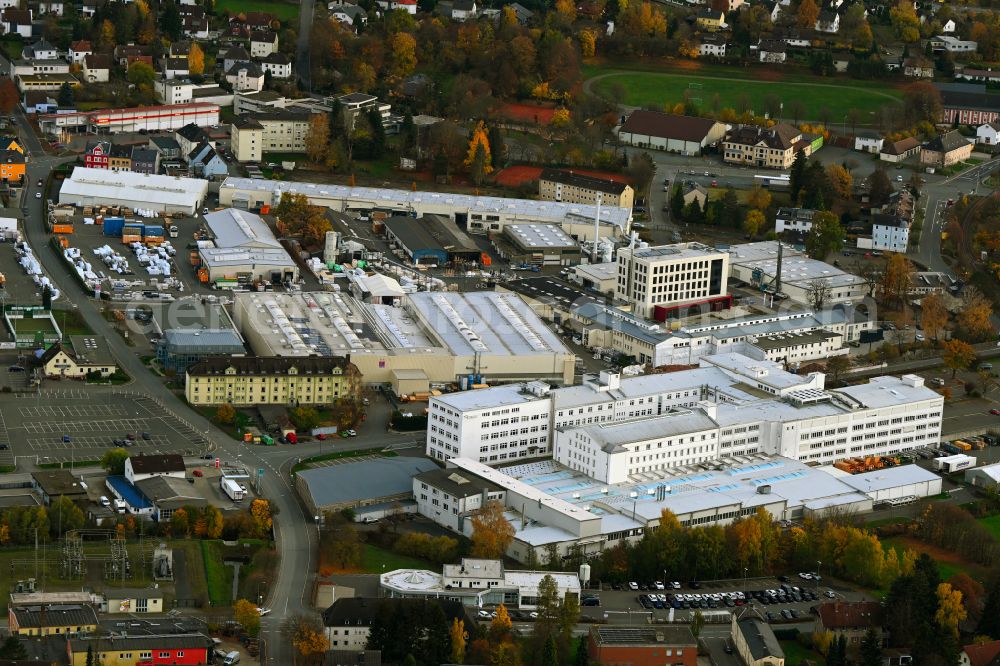 Aerial image Rehau - Autumnal discolored vegetation view building and production halls on the premises REHAU Industries SE & Co. KG on street Zehstrasse in Rehau in the state Bavaria, Germany