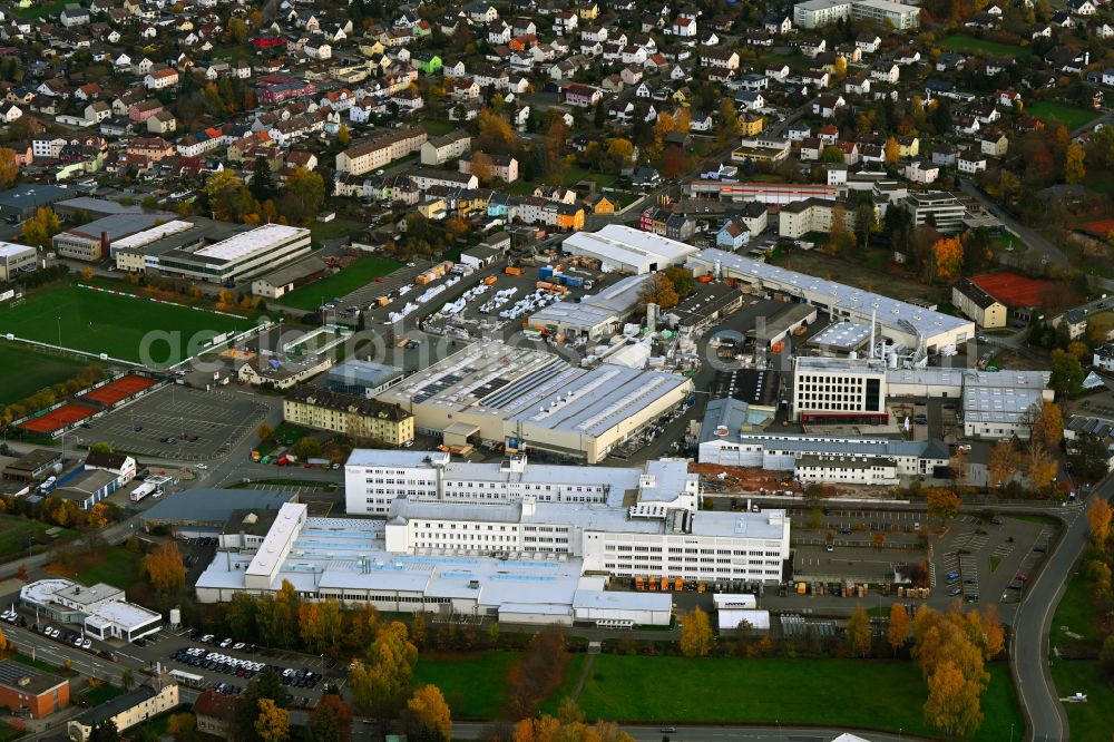 Aerial photograph Rehau - Autumnal discolored vegetation view building and production halls on the premises REHAU Industries SE & Co. KG on street Zehstrasse in Rehau in the state Bavaria, Germany