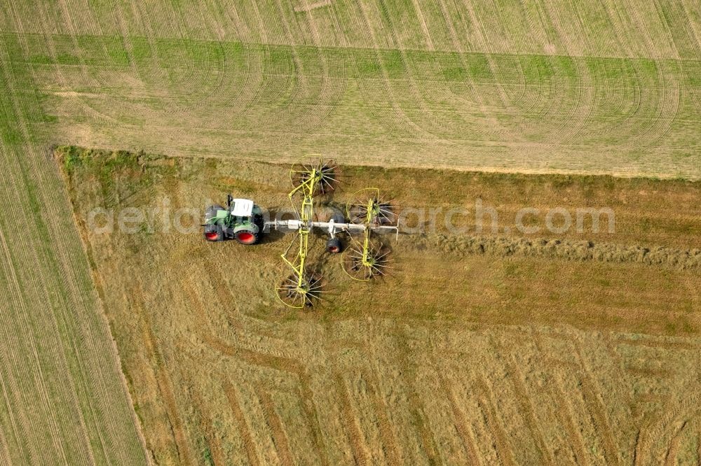 Aerial image Gladbeck - Tractor with tedder on agricultural fields in Gladbeck in the federal state North Rhine-Westphalia