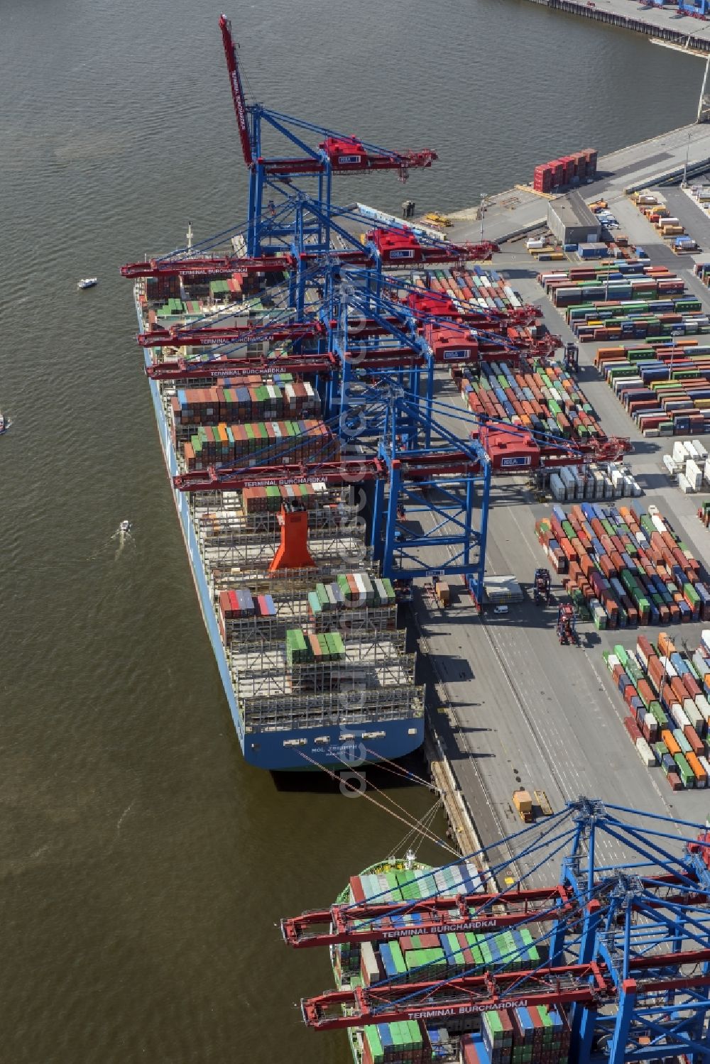 Hamburg from above - View on container and container ships at berth HHLA Logistics Container Terminal Burchhardkai and Walter Hofer Euro Gate Container Terminal in the Port of Hamburg harbor in Hamburg. Containership MOL Triumph