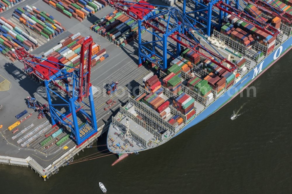 Aerial image Hamburg - View on container and container ships at berth HHLA Logistics Container Terminal Burchhardkai and Walter Hofer Euro Gate Container Terminal in the Port of Hamburg harbor in Hamburg. Containership MOL Triumph