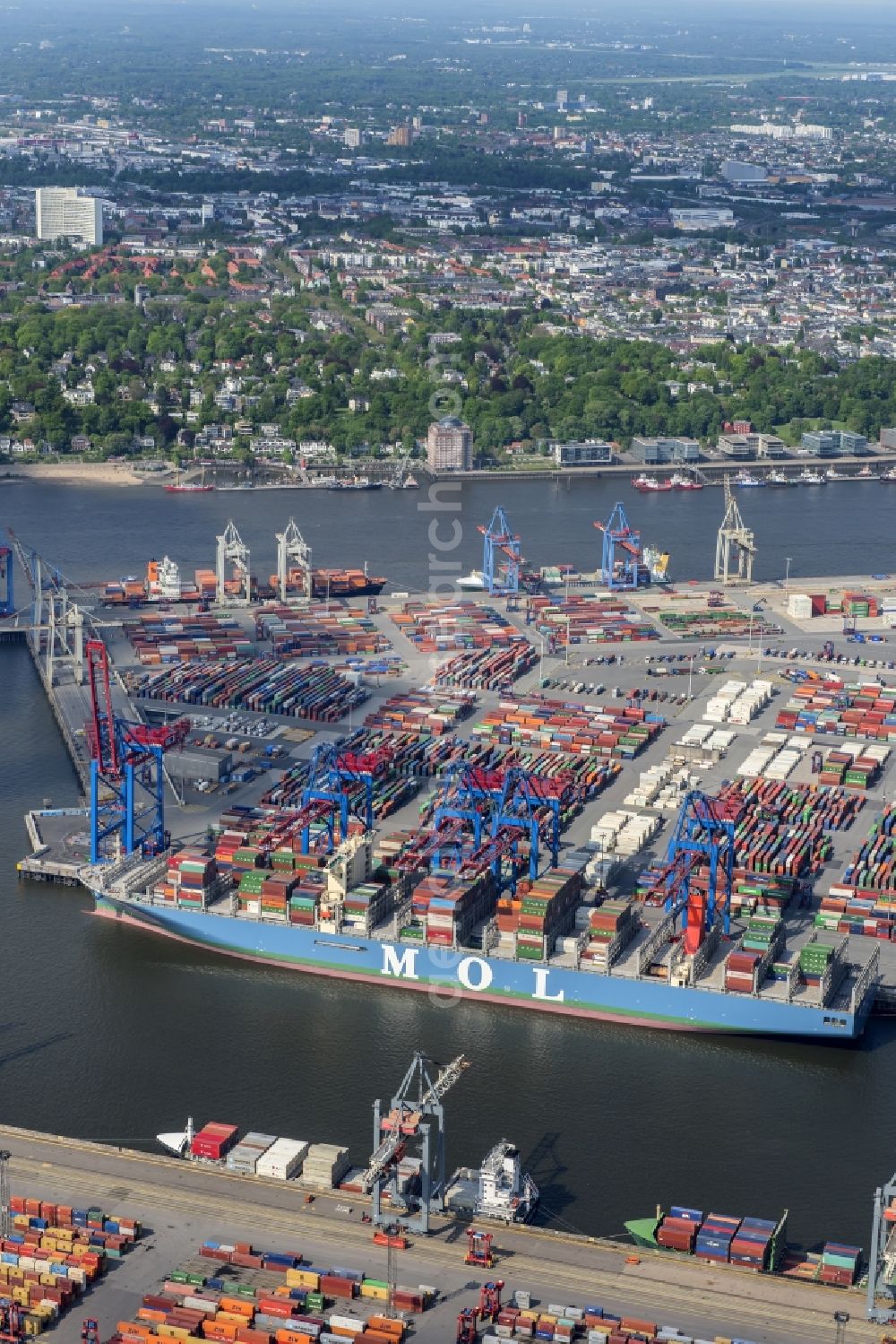 Hamburg from above - View on container and container ships at berth HHLA Logistics Container Terminal Burchhardkai and Walter Hofer Euro Gate Container Terminal in the Port of Hamburg harbor in Hamburg. Containership MOL Triumph