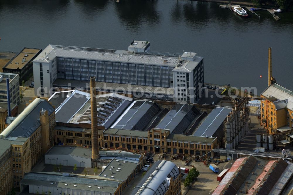 Aerial photograph Berlin - Historic factory buildings and university building on the industrial area on Wilhelminenhofstrasse on the riverbank of the Spree in the Oberschoeneweide part of Berlin in Germany. The building with its chimney and yellow facade is located on the river