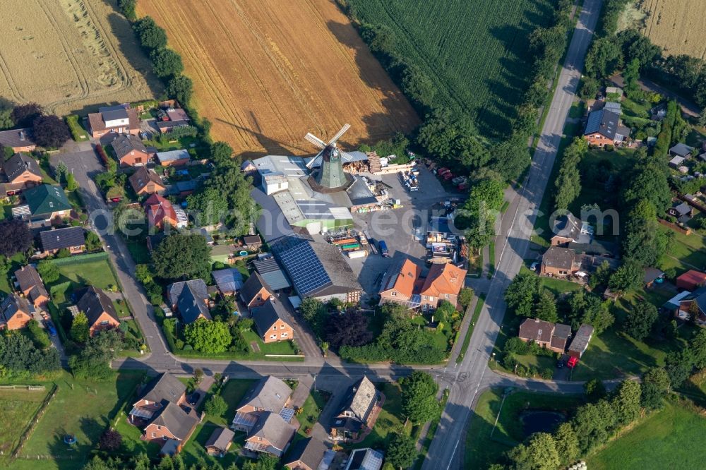 Aerial image Süderhastedt - Historic windmill on a farm homestead of Hass Landhandel on the edge of cultivated fields in Suederhastedt in the state Schleswig-Holstein, Germany