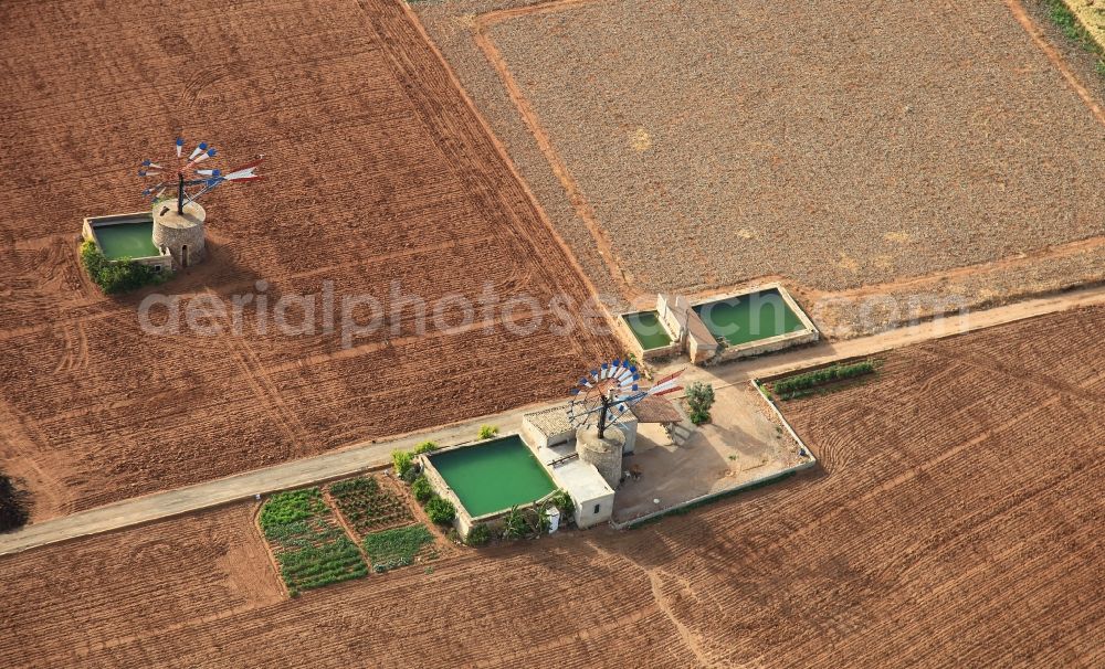 Sa Pobla from above - Historic windmill on a farm homestead on the edge of cultivated fields in Sa Pobla in Balearic Islands, Mallorca, Spain